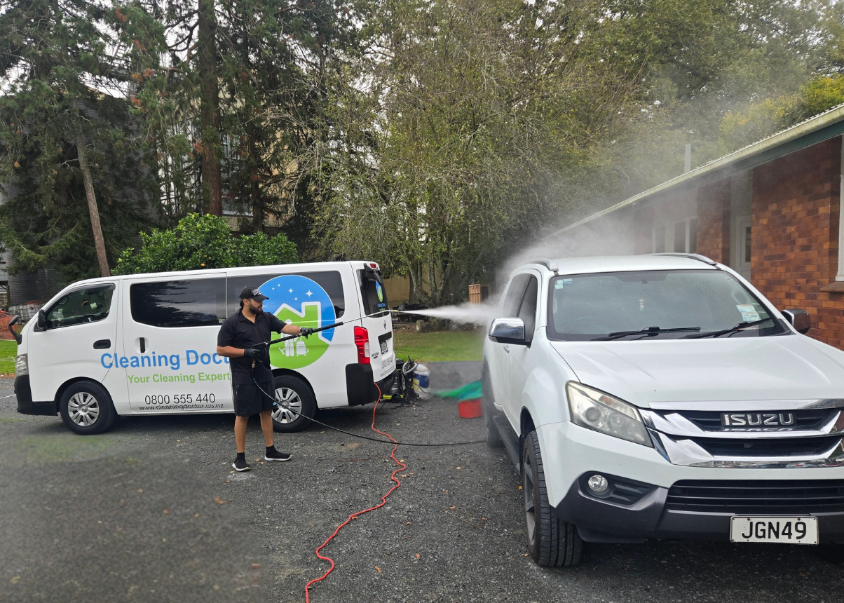 Professional mobile car groomer from Cleaning Doctor performing exterior washing on a SUV in an Auckland driveway